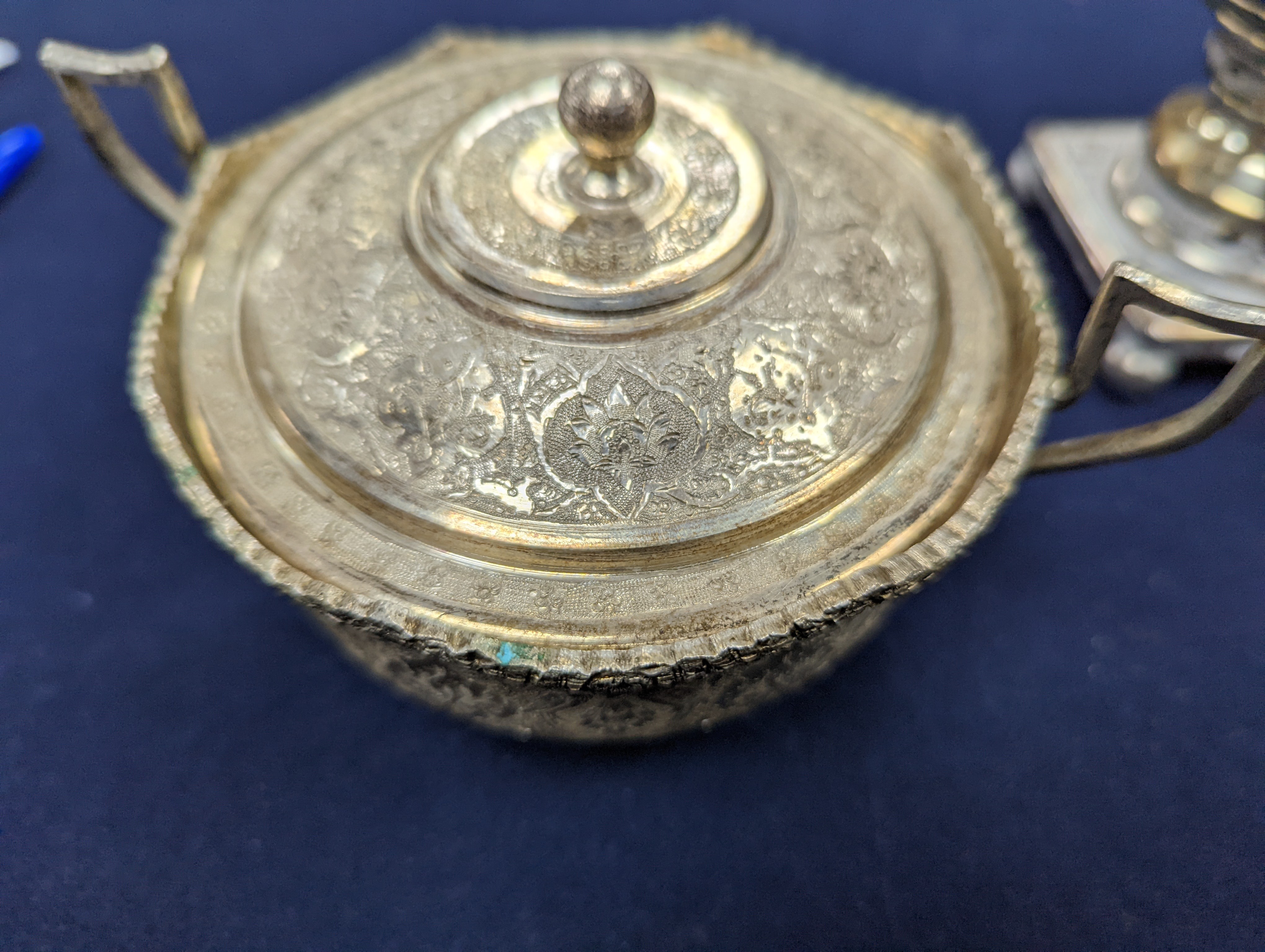 A set of six Persian embossed 84 standard white metal coffee cup holders and matching sugar bowl and cover by Vartan and four other Persian white metal items.